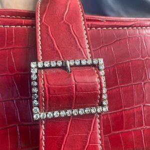 Apostrophe purse good cond 1 stone missing from buckle/slight blemish in corner